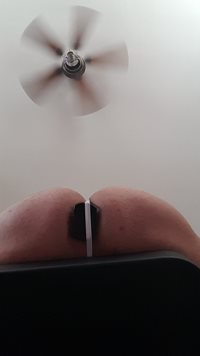 Under butt with man thong and large plug in