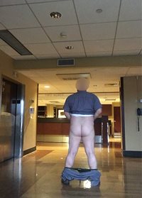 Pants down in front of the nurse's station beside the elevator. Nurses were...