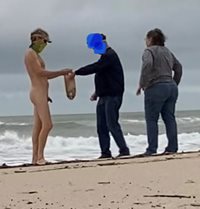 nude beach talking with clothed people
