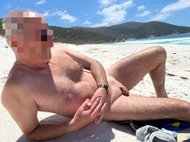 My sexy NUDE male lover catching some sun next to me at the beach