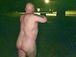 Standing at the fence naked and waiting to see if any bar flies are going t...