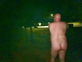 Standing at the fence naked and waiting to see if any bar flies are going t...