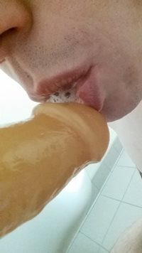 Sucking on my third dildo while I ram the other up my ass